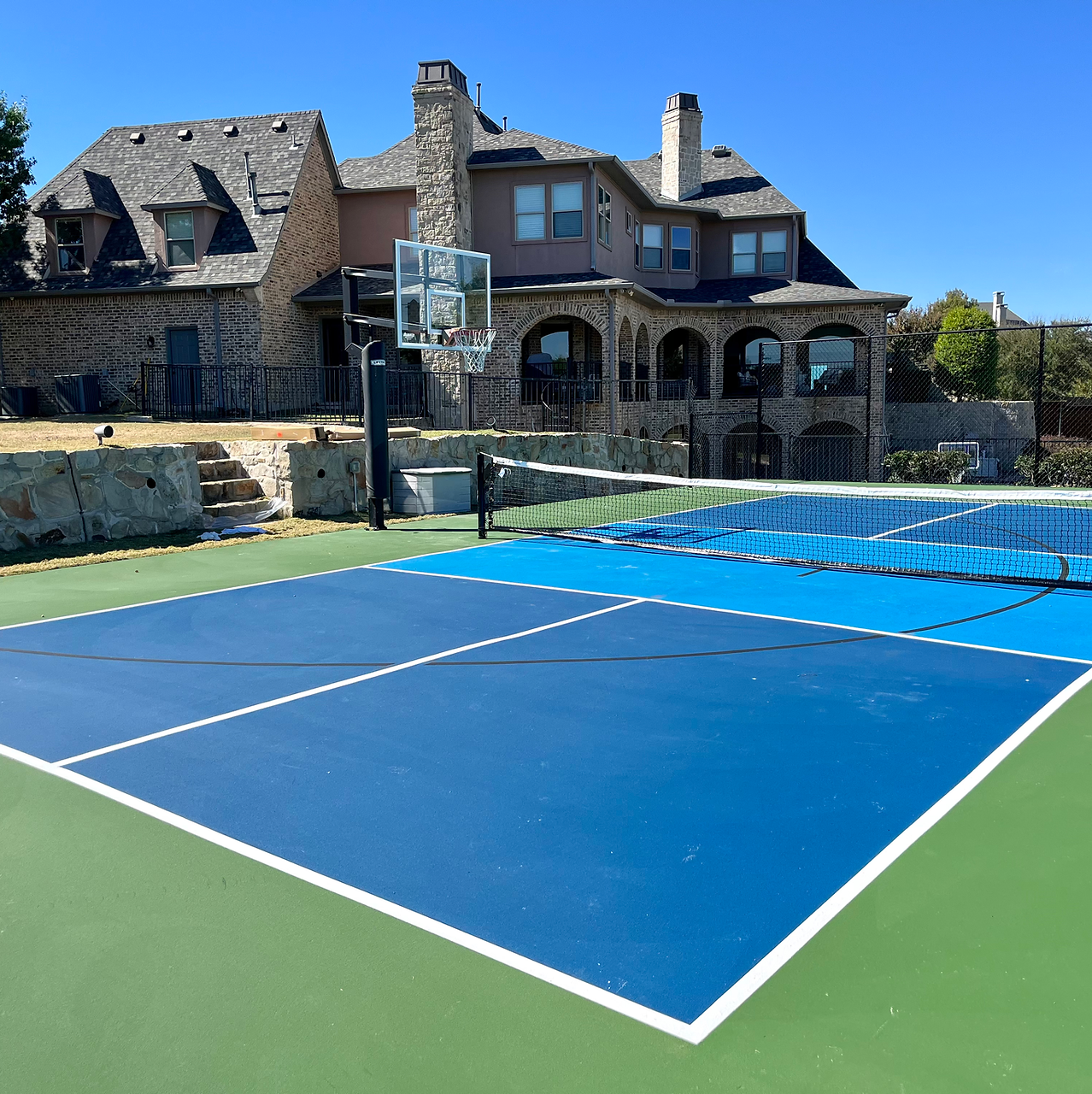 A backyard basketball and pickleball court