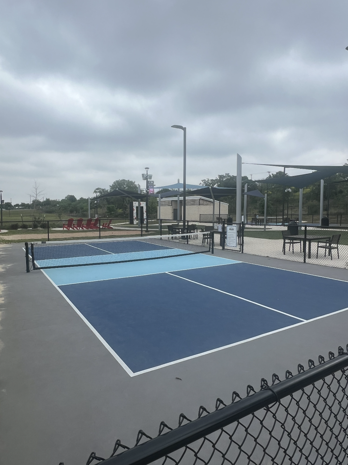 A person stretching on a pickleball court